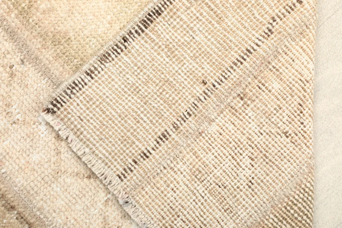 Close-up of the rug's backside, revealing the hand-knotted cotton foundation.