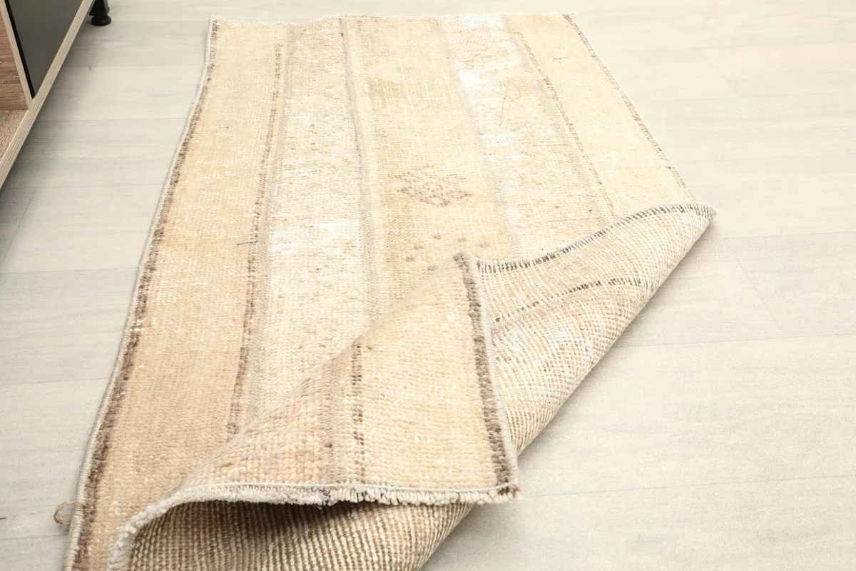 The rug partially folded, showing both the pile side and the woven foundation.