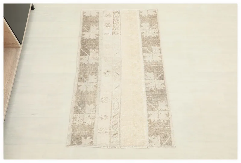 Full overhead view of the beige and brown patchwork vintage Anatolian rug