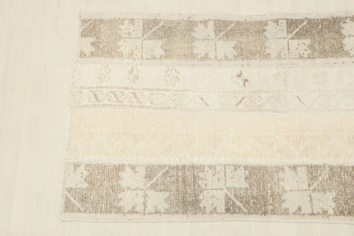 Detail shot of the rug's design, focusing on the interplay of colors and motifs