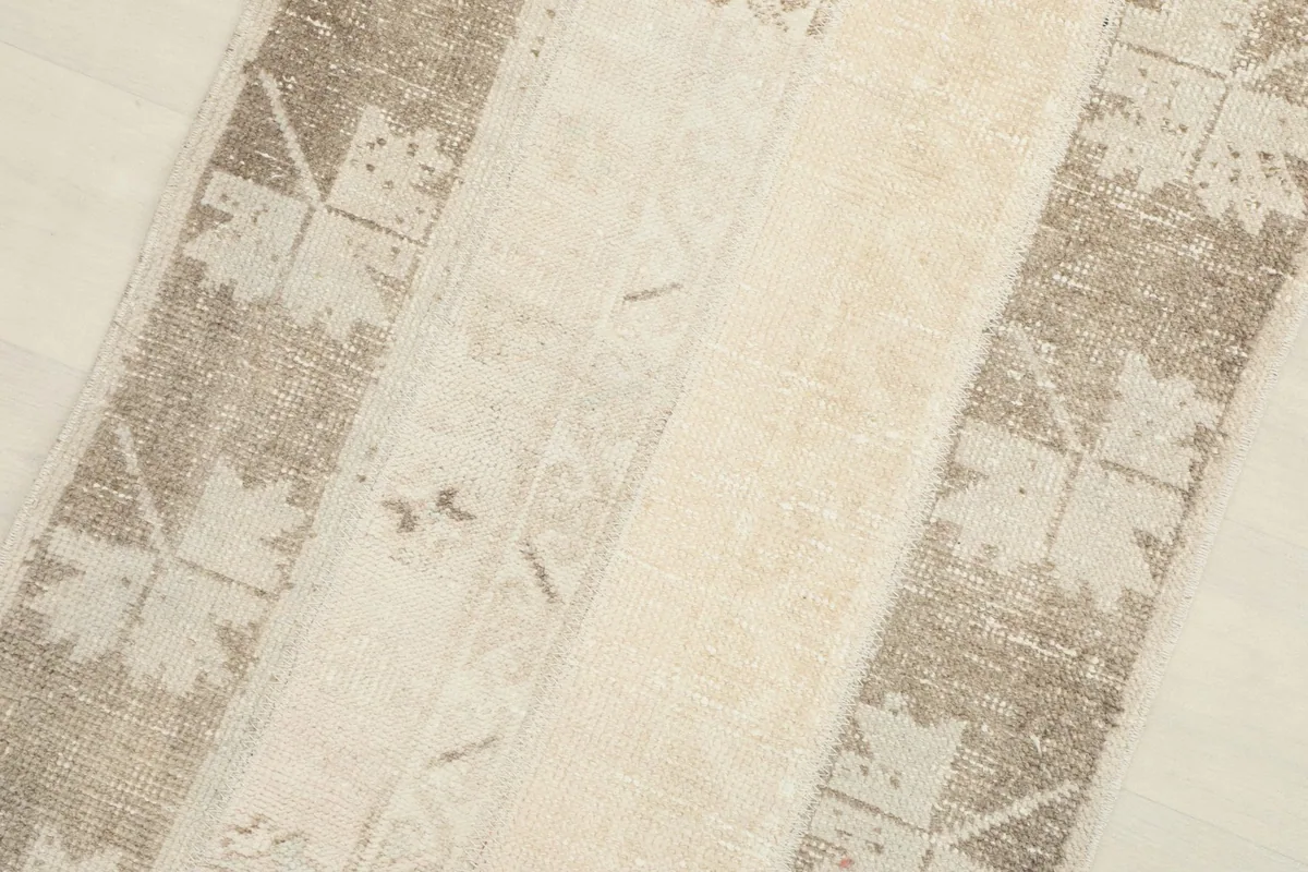 Angled close-up showing the rug's patchwork construction and varied texture