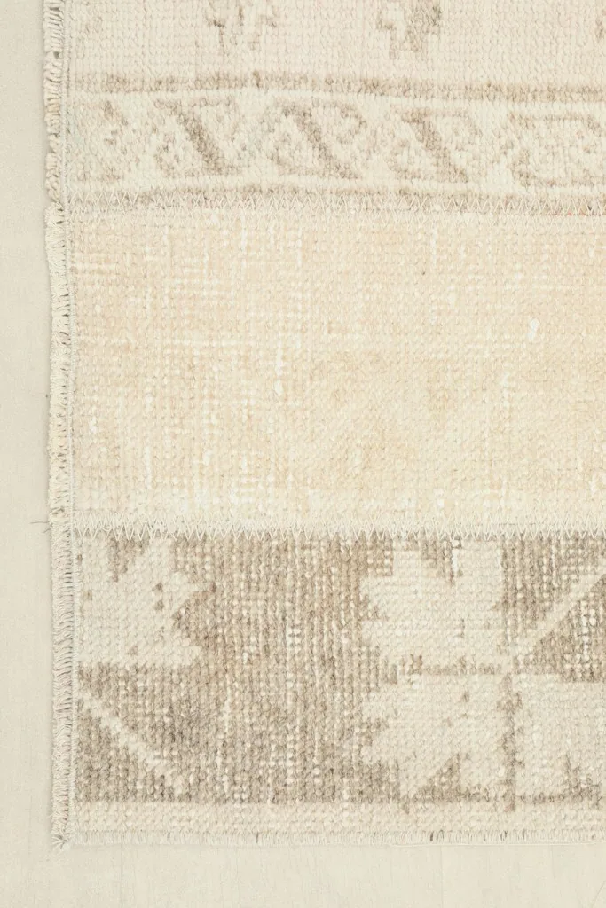 Edge view of the rug, showing the hand-knotted construction and fringe detail