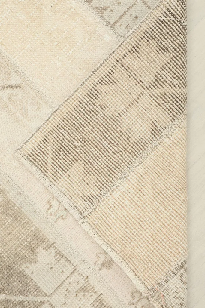 View of the rug's backside, showcasing the durable cotton foundation and knotting