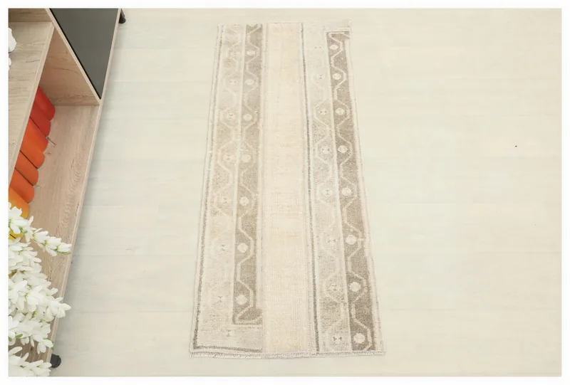 Full top view of the 1'8" x 4'0" beige and tan geometric vintage Anatolian rug on a white background.