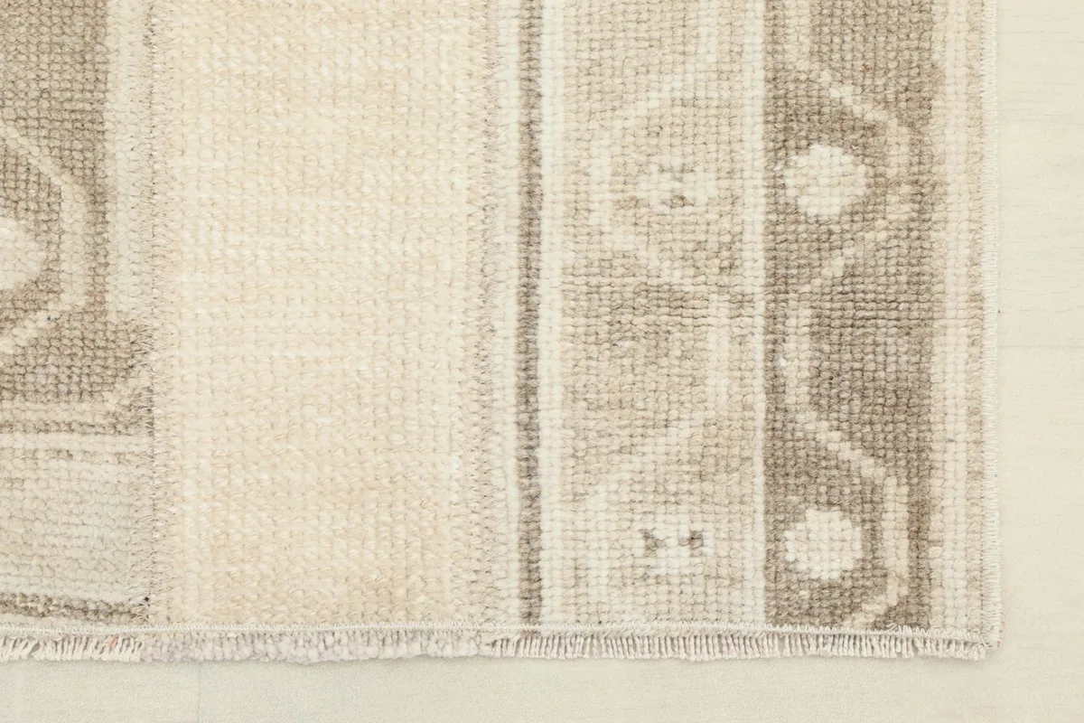 Detail of the rug's short fringe and the tightly woven edge, showcasing the craftsmanship.
