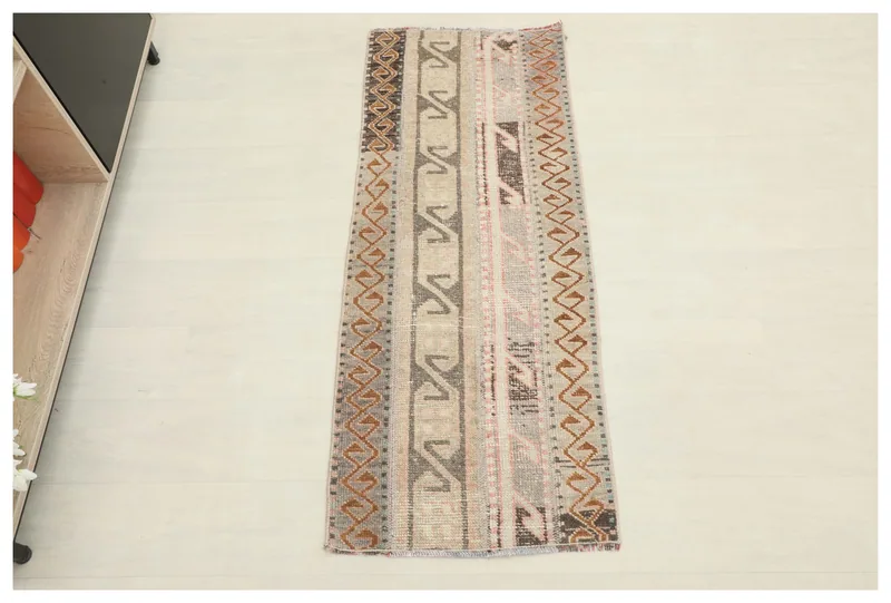Full top view of the 1'9" x 4'6" beige, brown, and rust runner rug on a white background.