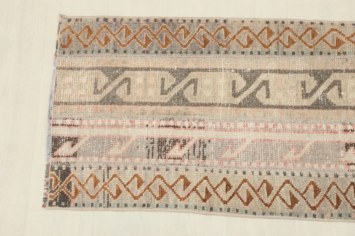 Close-up showing a section of the rug with its distinct geometric motifs and color variations.