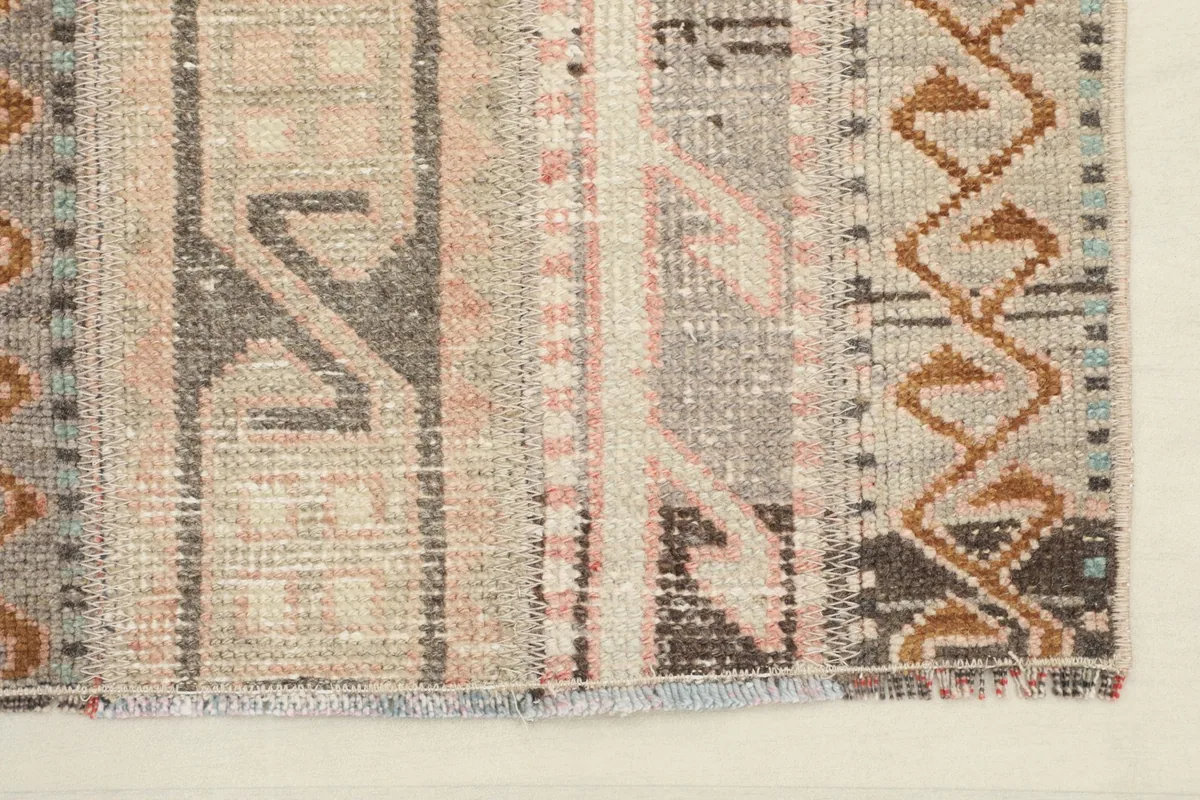 End of the runner rug, showing the finishing and slight fringe details.