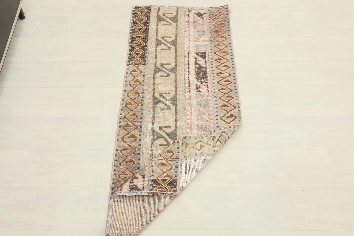 The runner rug folded, indicating its flexibility and material thickness.