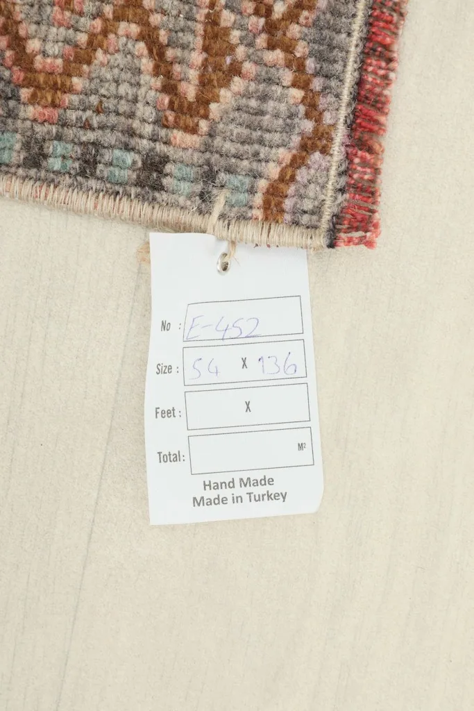 Tag showing the rug's dimensions in centimeters (54 x 136 cm) and origin as Hand Made in Turkey.