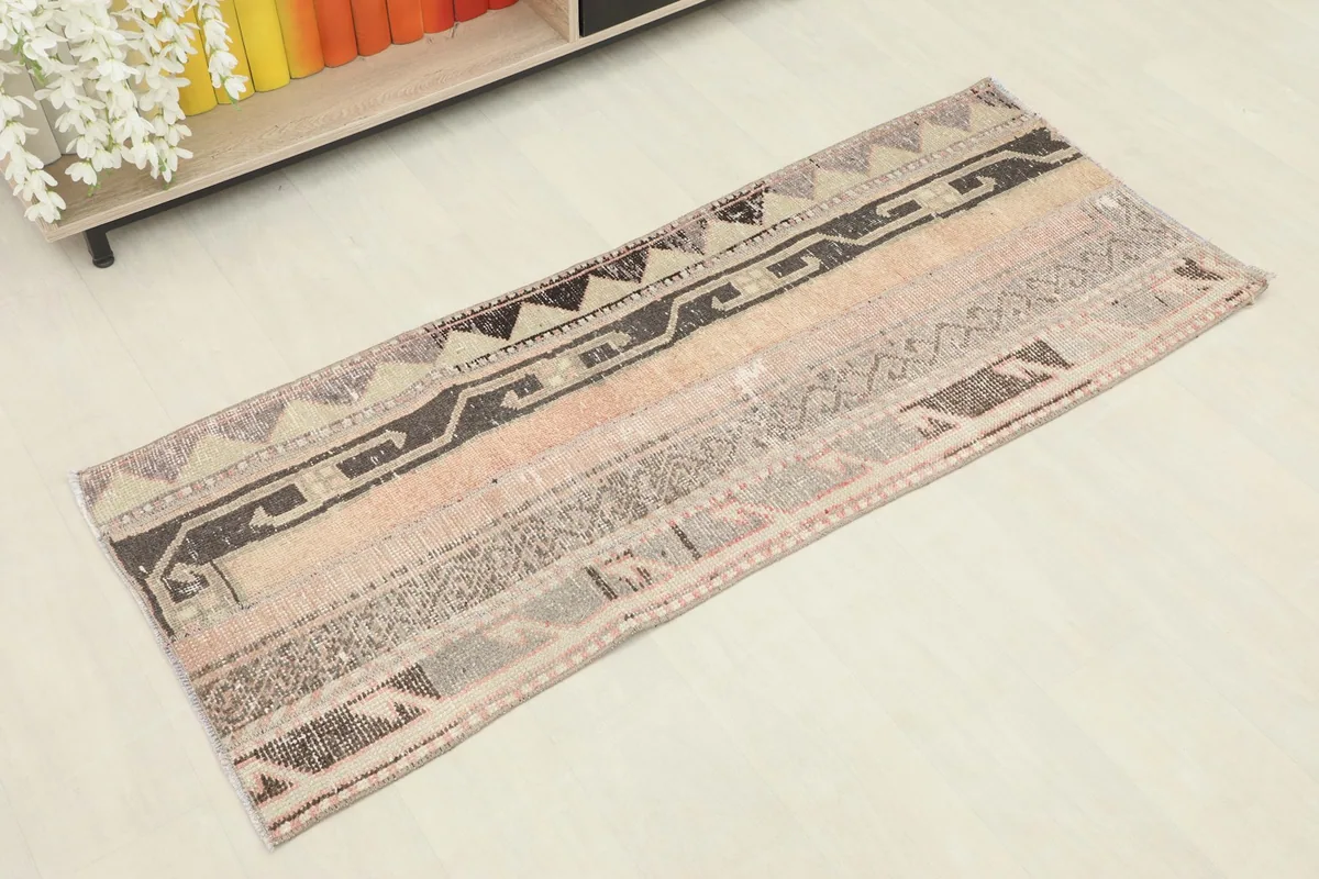Angled view of the hand-knotted Anatolian runner, showing its varied patchwork sections and colors.