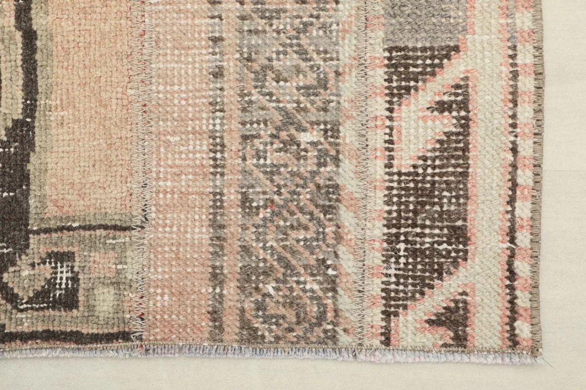 Edge view showcasing the varied patterns, colors, and the subtle wear on the hand-knotted runner.