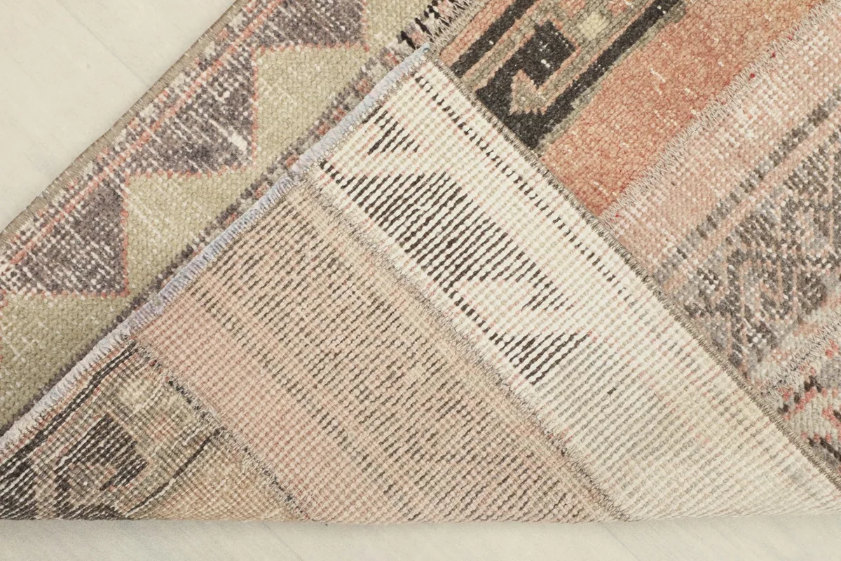 View of the back of the runner, showing the hand-knotted cotton foundation and wool construction.
