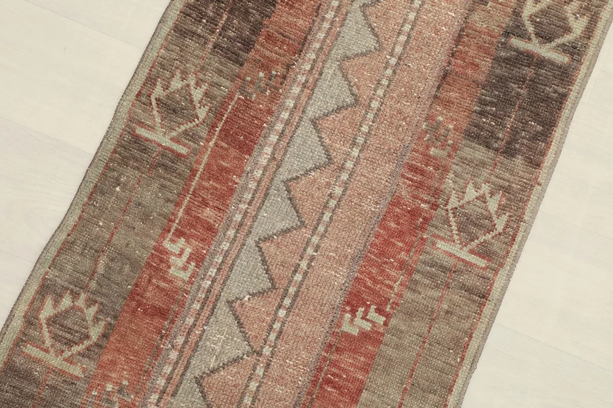 Close-up angled view of the rug's central design elements and color palette.