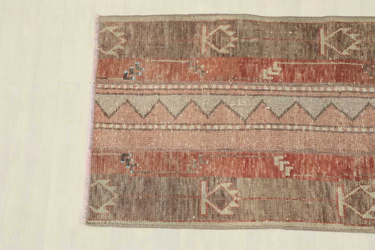 Overhead view focusing on the upper portion of the rug, showing color variations and patterns.