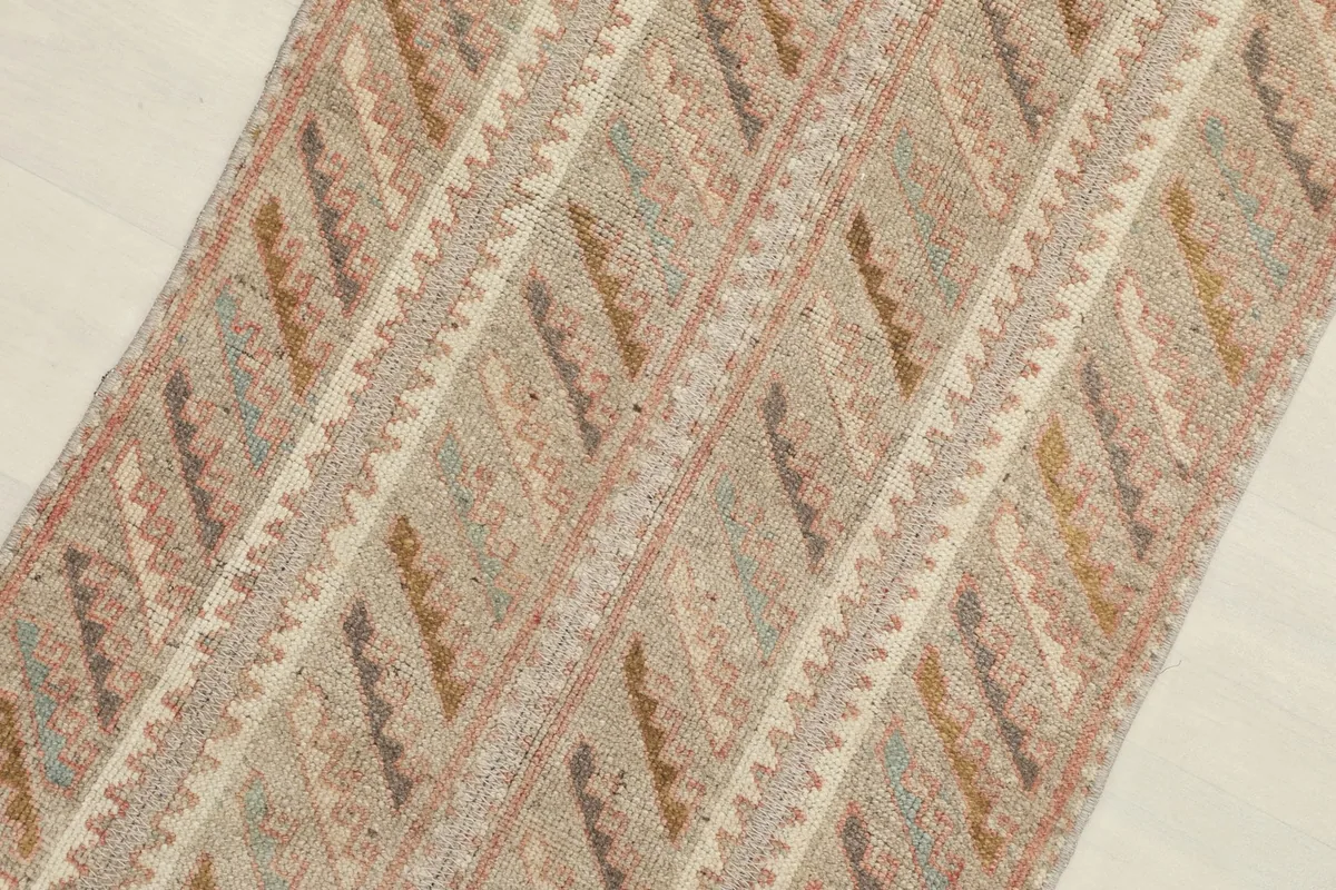 Detailed view of the rug's surface, revealing the texture of the wool pile and color variations.