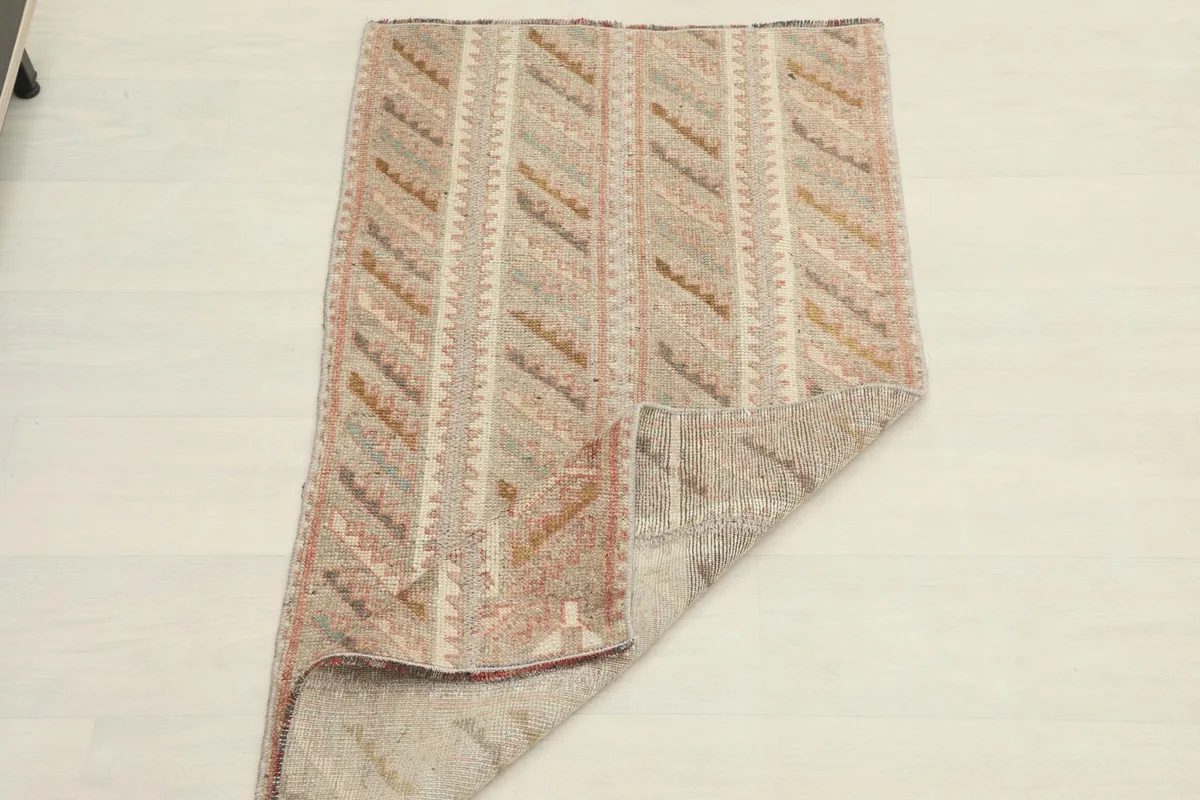 The rug partially folded, showing its flexibility and the reverse side.