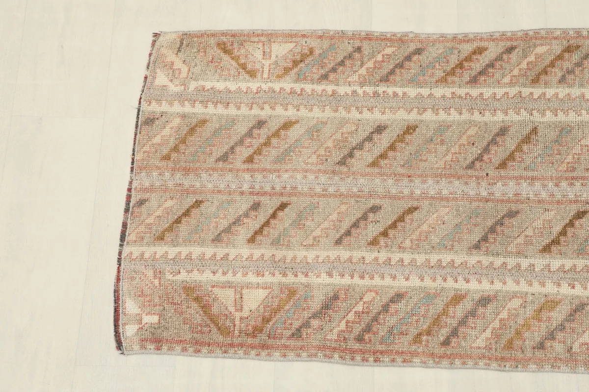 Overhead view focusing on one end of the rug, showing the intricate tribal motifs.