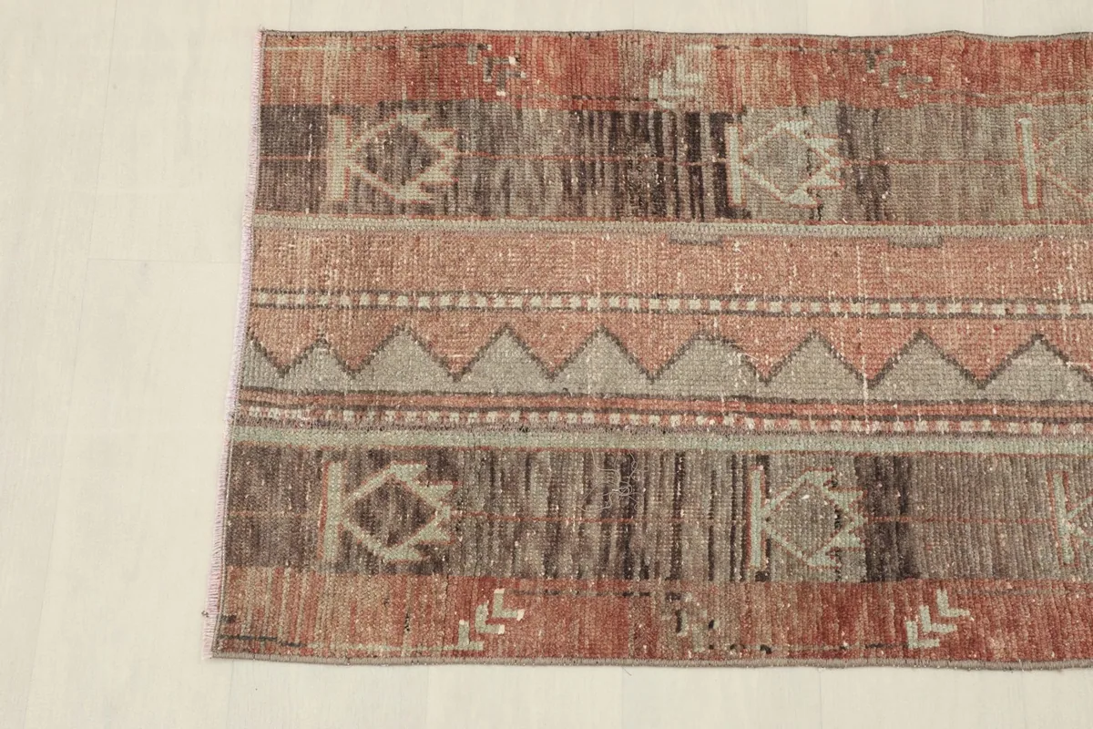 Detail photo of the geometric and tribal patterns on the vintage Anatolian rug.