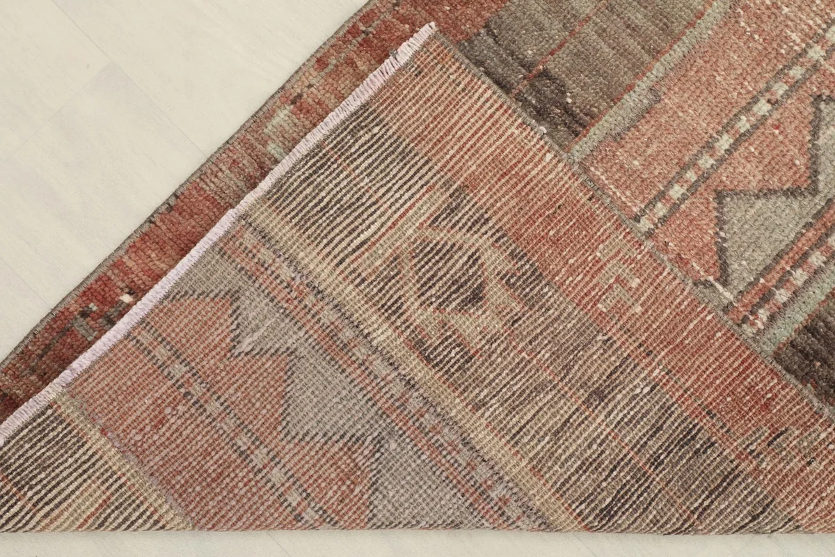 View of the back of the hand-knotted rug, showing the cotton foundation and knotting detail.