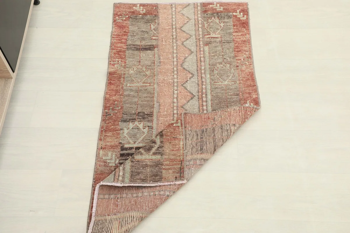 The rug partially folded, illustrating its flexibility and showing the full pattern from an angle.