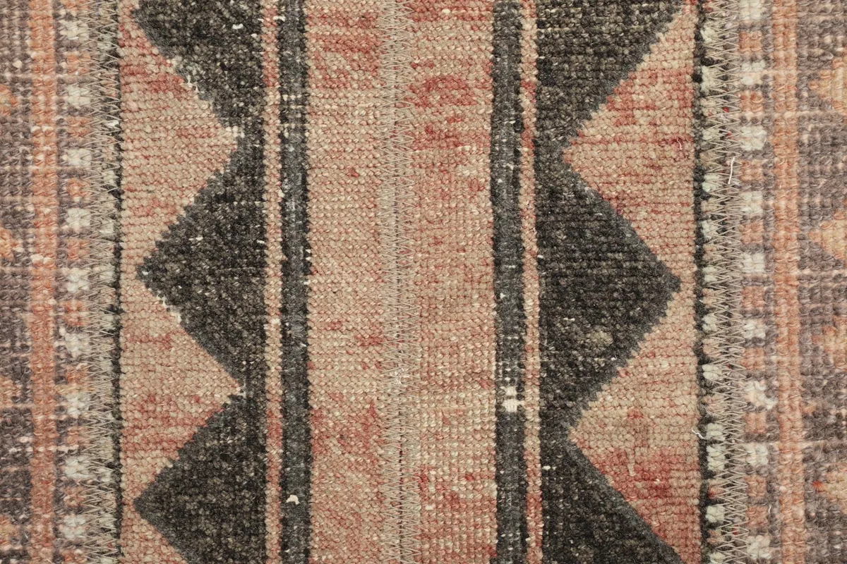Very close detail of the hand-knotted wool pile, showing individual knots and color blend.