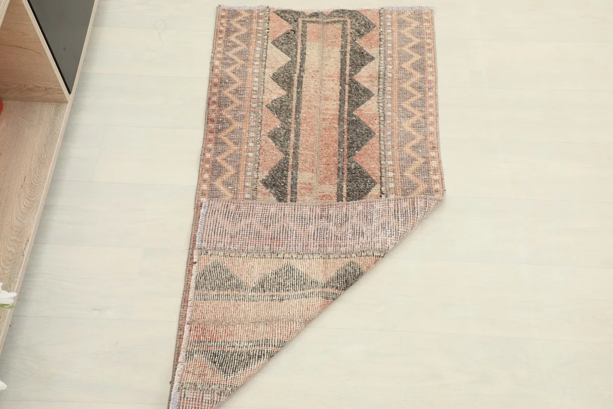 The rug folded to show its flexibility and thickness, with patterns visible on both sections.