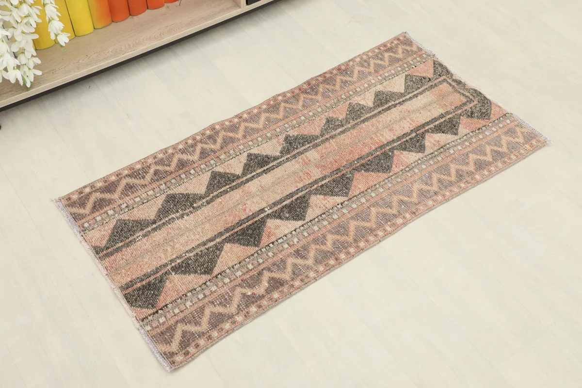 Slightly angled overhead view of the small hand-knotted rug, showing its full design.