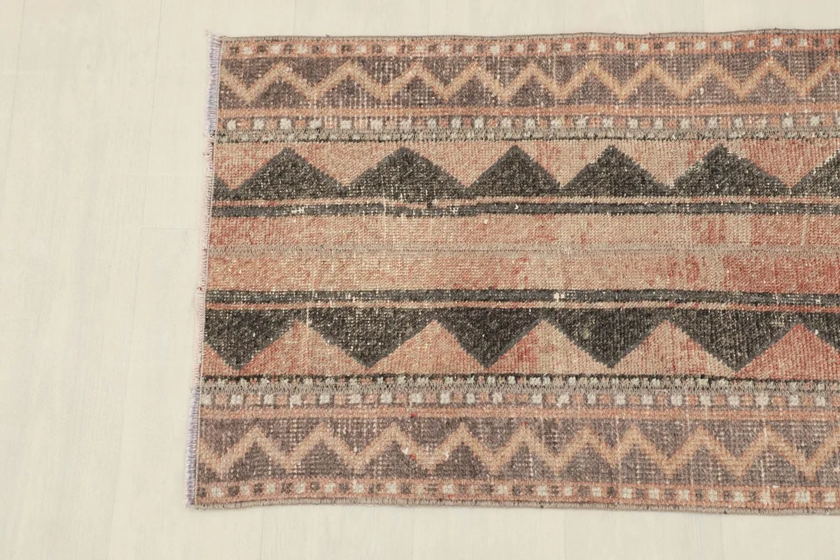 Detailed overhead shot focusing on the geometric patterns and color variations within the rug.