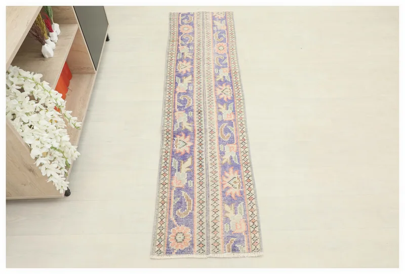 Full top view of the 1'8" x 6'4" vintage purple and beige runner rug on a white background.