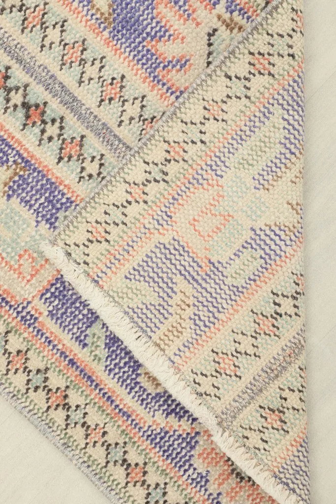 View of the back of the hand-knotted wool on cotton foundation, showing craftsmanship.