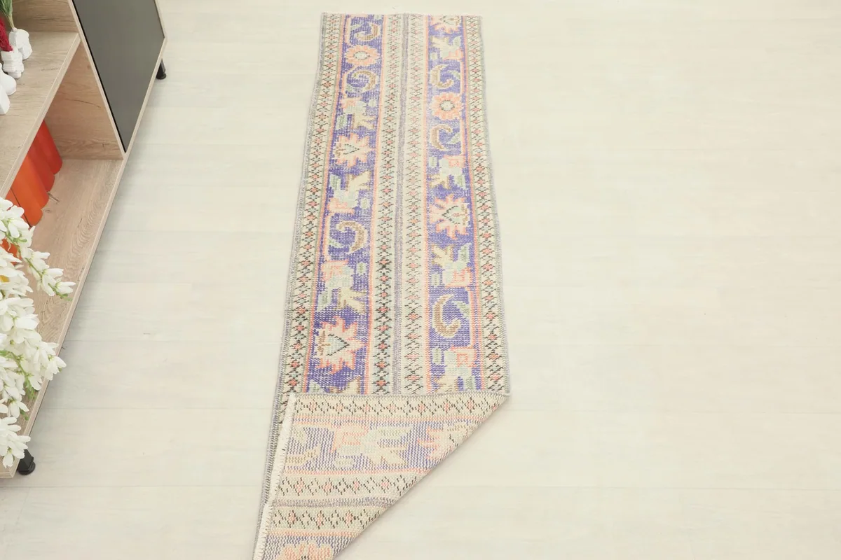 The runner rug partially folded, illustrating its flexibility and overall design.