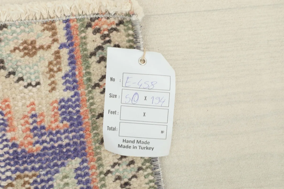 Close-up of the rug tag, confirming its hand-made origin in Turkey and size.