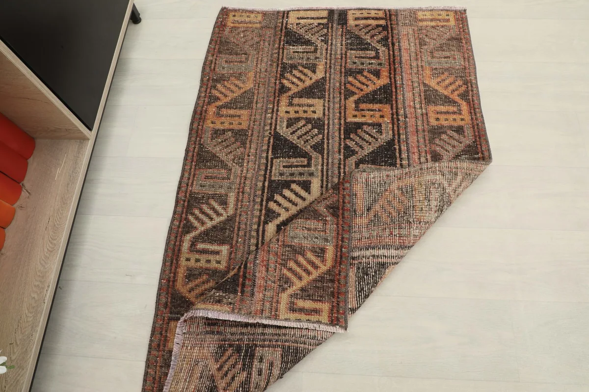 The rug partially folded, demonstrating its flexibility and construction