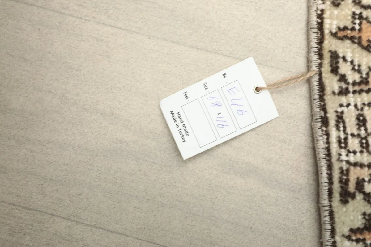 Corner of the rug with a label indicating its hand-made origin in Turkey and size.