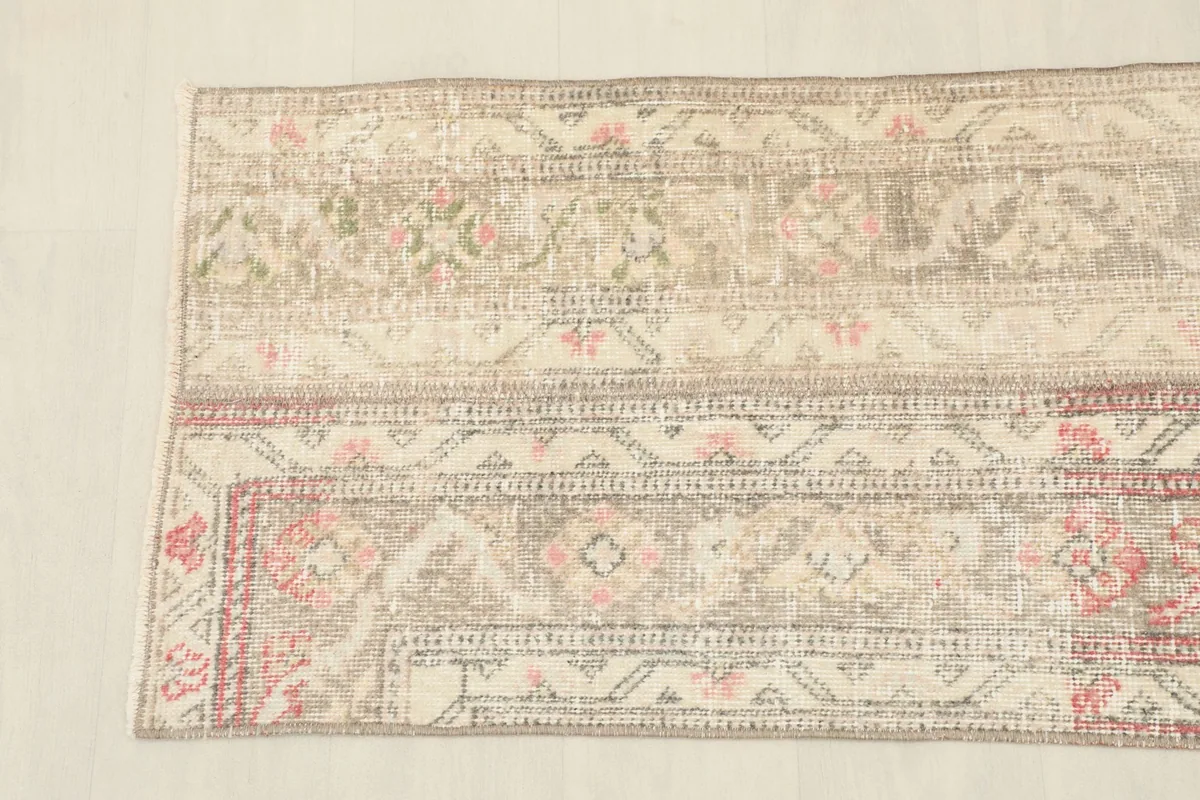 Detailed view of the varied patterns and color transitions within the vintage patchwork runner.