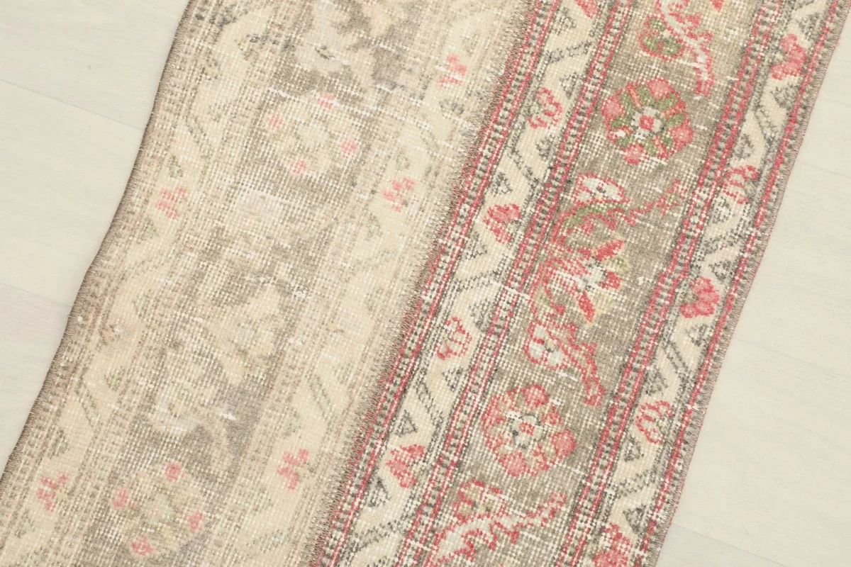 Close-up of the rose-colored patterned section alongside a muted tan and gray panel.