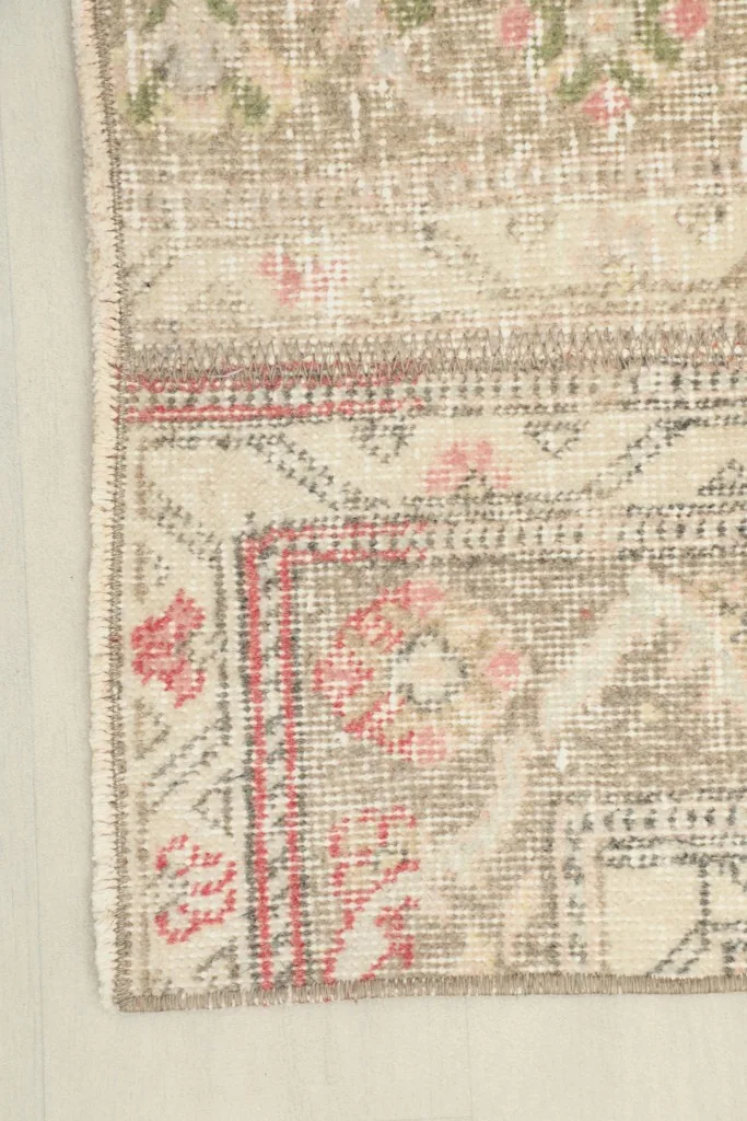 Corner detail showing the edge finishing and some of the geometric border patterns.