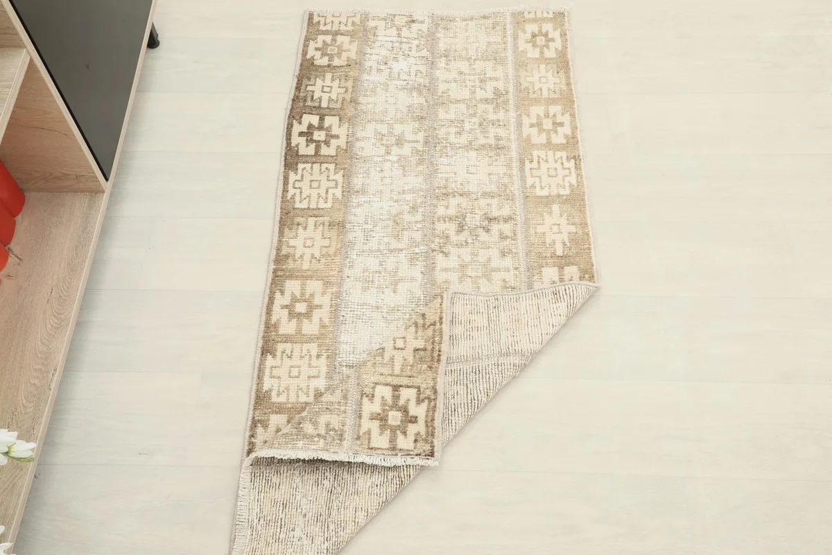 The rug partially folded, demonstrating its flexibility and the thickness of the material.