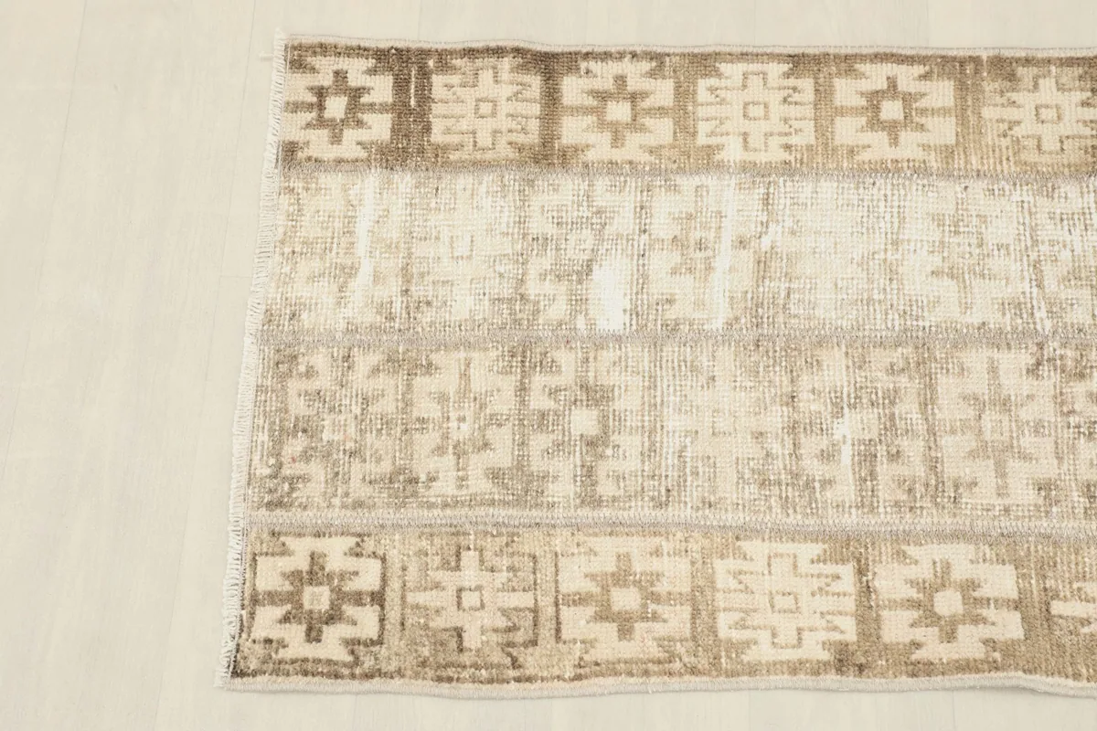 Overhead view focusing on the upper half of the rug, showing the consistent pattern and color variation.