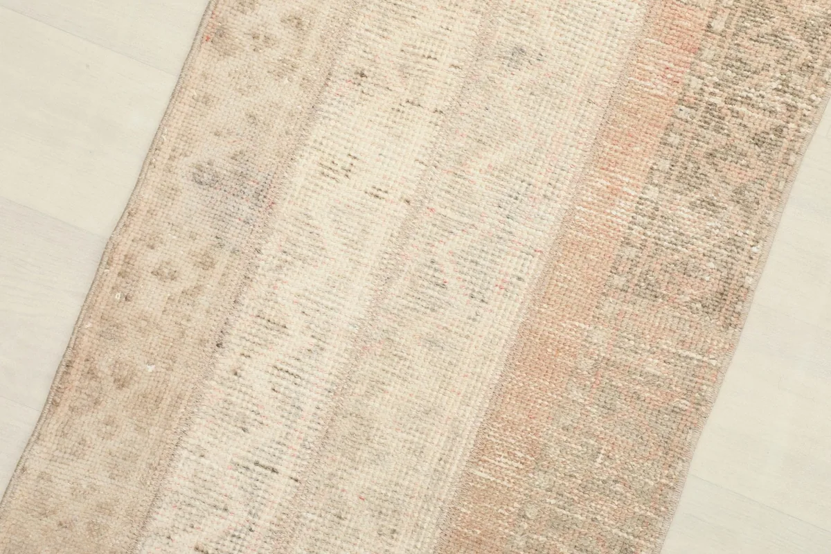 Close-up of the rug's mid-section, revealing the varied textures and colors of the patchwork construction.