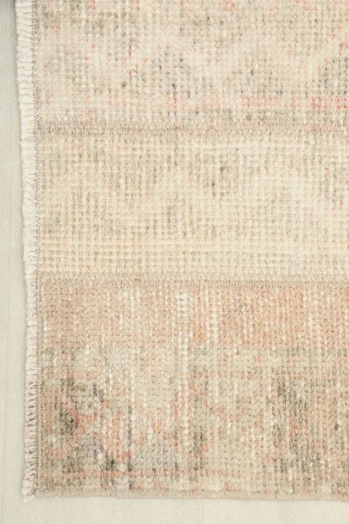 Close view of one end of the rug, detailing the pile and the subtle color shifts in the patchwork.