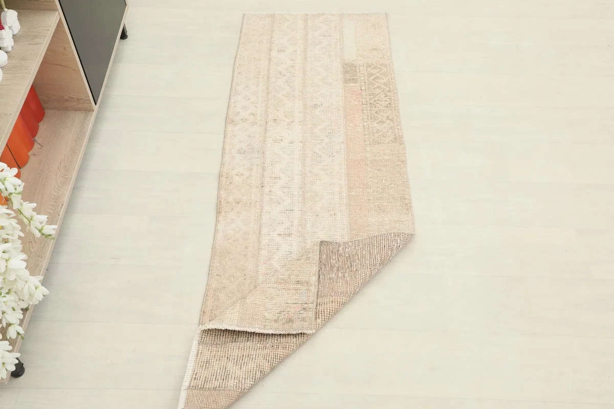 The runner rug partially folded, showing its flexibility and how it lays on the floor.