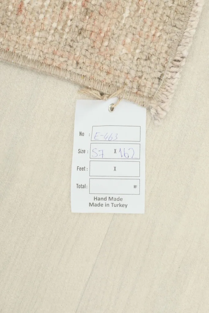 Product tag showing the rug's dimensions and 'Hand Made in Turkey' alongside the rug.