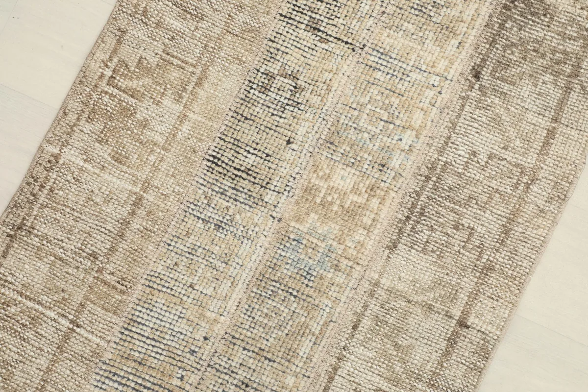 Detailed view of different sections of the rug, showing subtle blue threads within some of the darker patches.