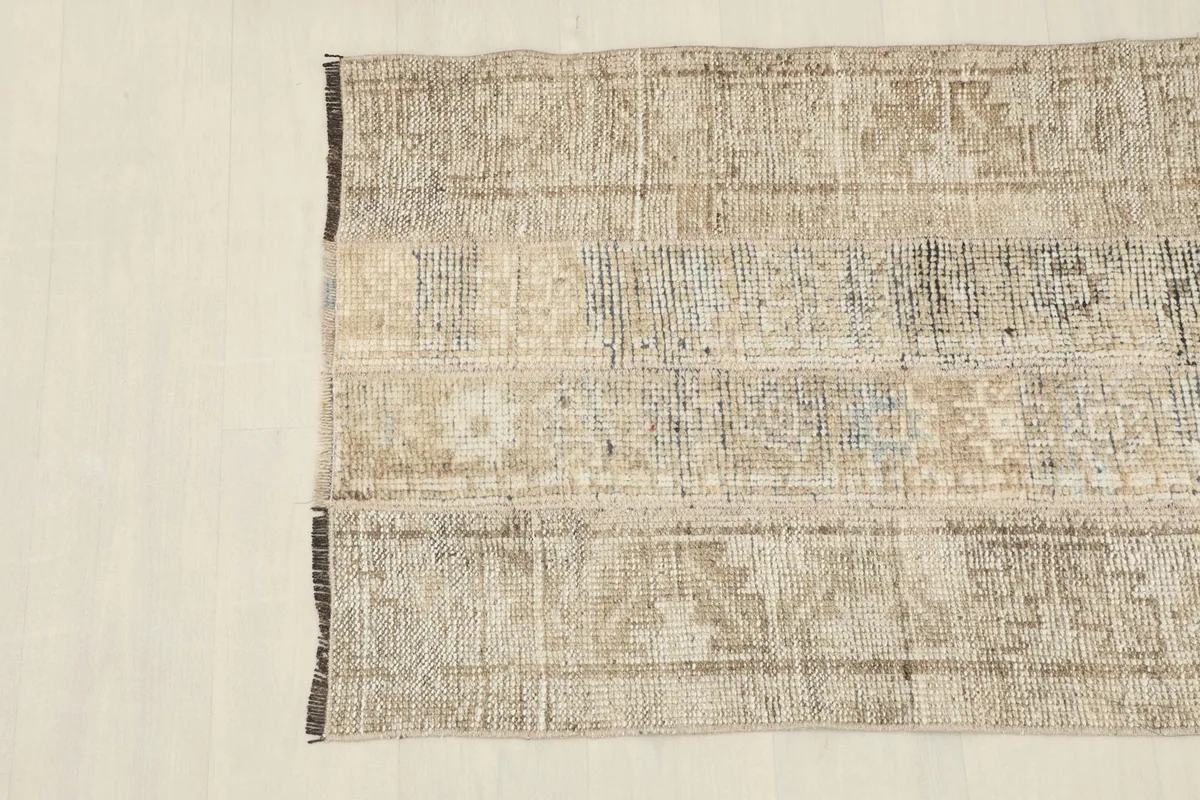 Overhead shot focusing on the central and left side of the rug, revealing the intricate patchwork construction.