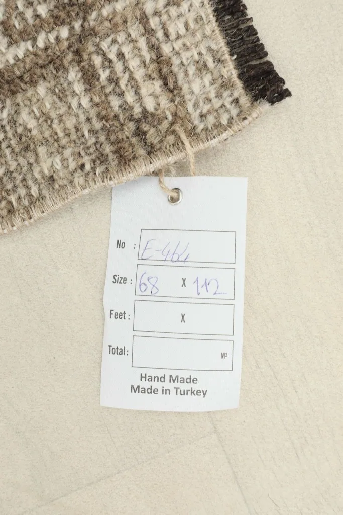Photo of the rug's tag, confirming 'Hand Made Made in Turkey' and the size in centimeters.