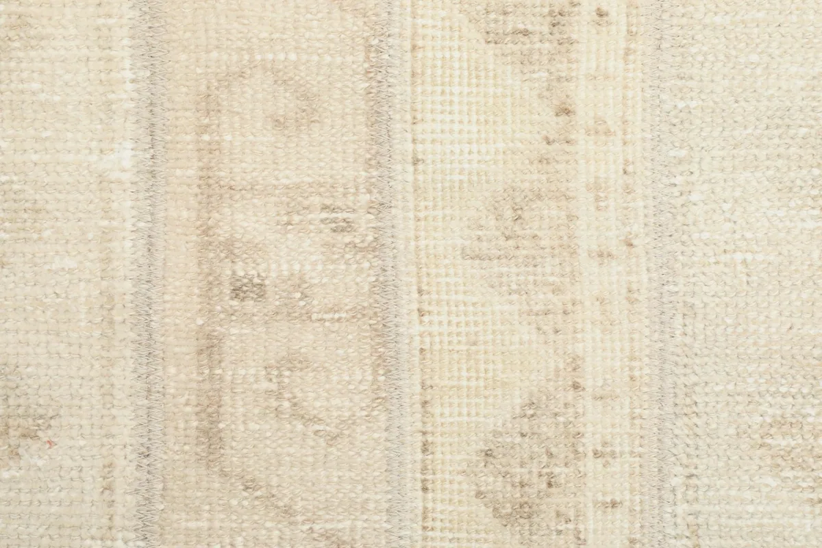 Close-up detail of the rug's low wool pile, revealing the hand-knotted texture and soft patina.
