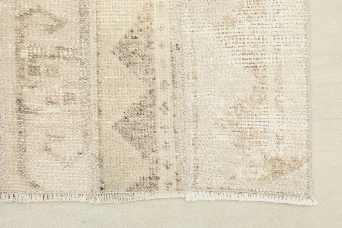 Detail showing the fringe and edge finish of the rug, with visible hand-knotted construction.
