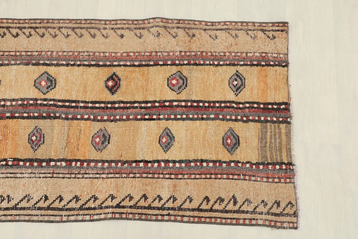 Close-up of the rug's central design, showing geometric motifs and color bands.